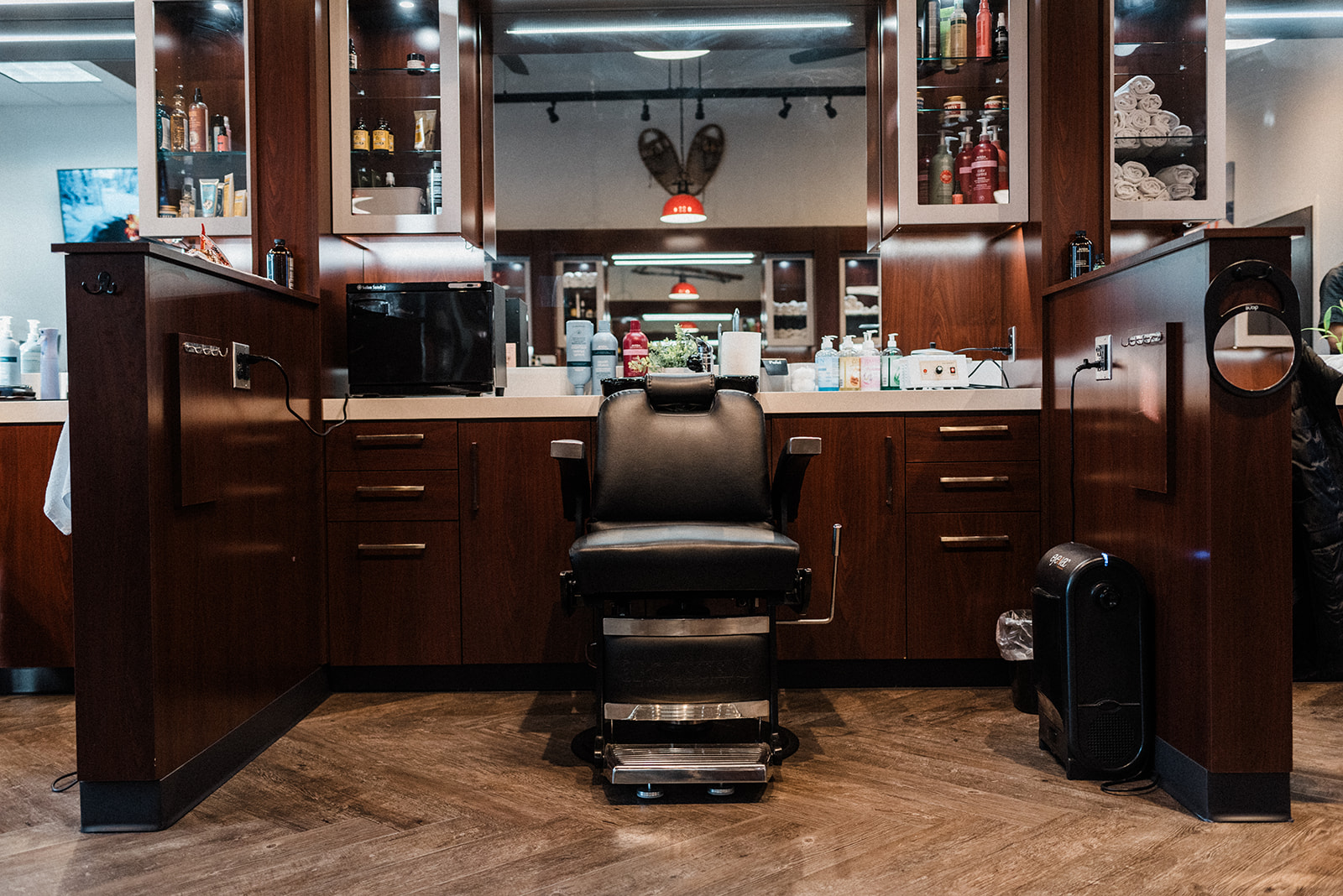 Classic barber chair at a wood-paneled station
