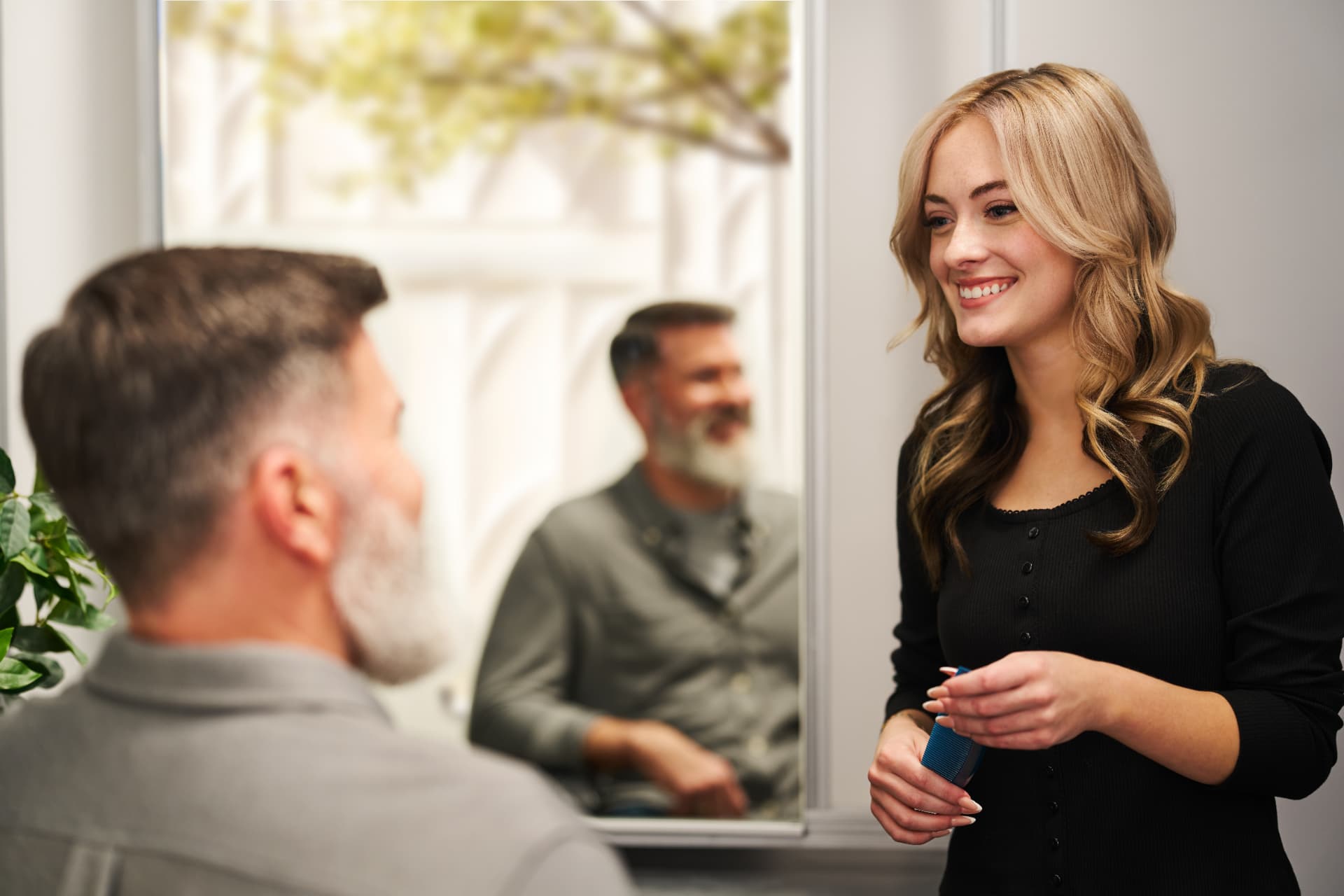 Stylist consulting with a bearded guest at the mirror